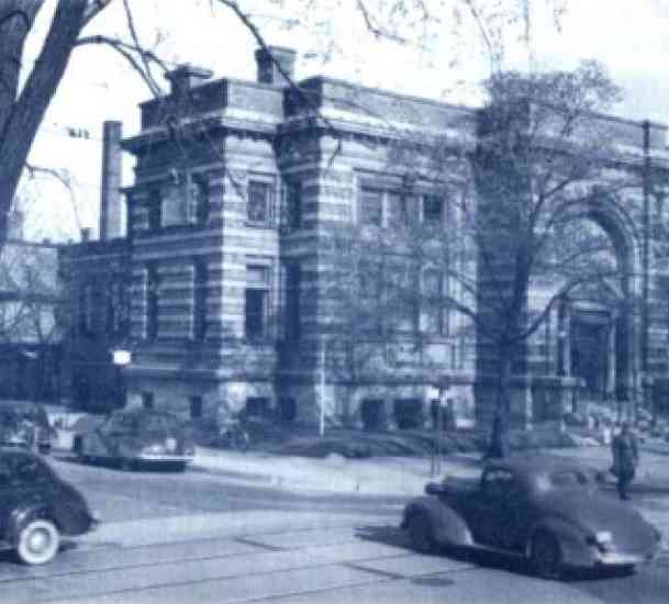 A black and white photo of the library's second home and Racine's first Carnegie library, a stone building in the Renaissance Revival style at 701 South Main Street.