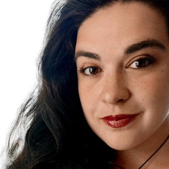 Dreams Ramirez headshot - square Dreams Ramirez, a light-skinned, feminine person with long, dark hair and red lipstick.